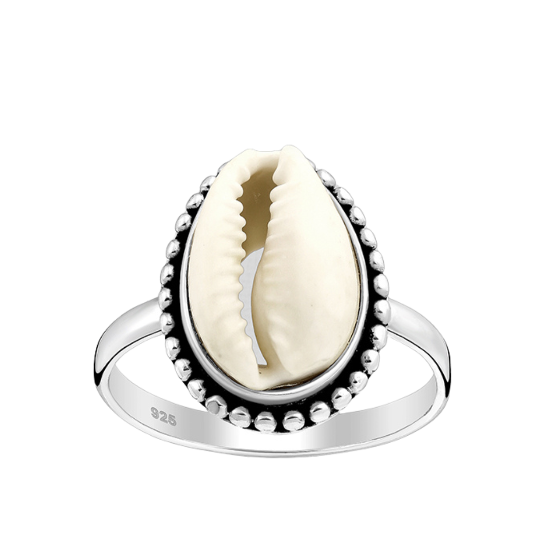 cowrie shell ring in sterling silver with a white background