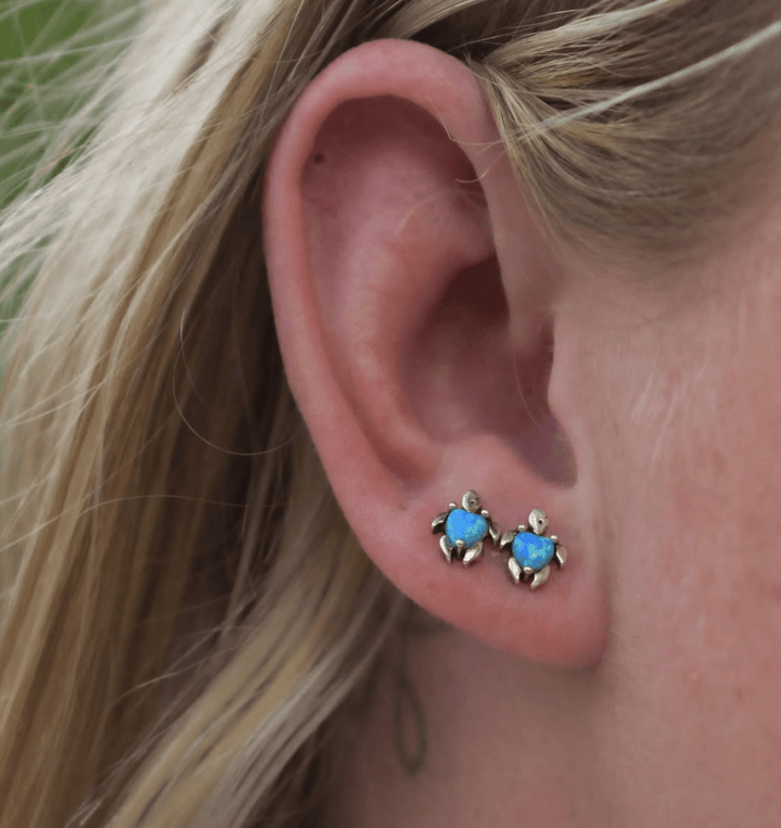 Ocean-themed turtle earrings with lab-grown blue opal styled in a beachy jewellery look