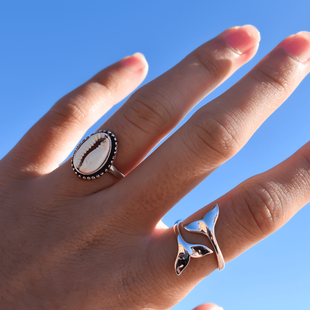 cowrie shell and Whale tail ring in sterling silver worn on finger, minimalist ocean-themed ring