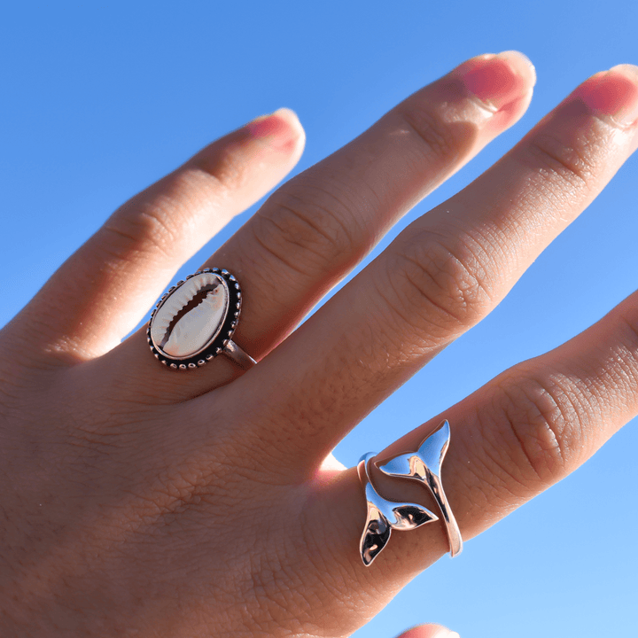 cowrie shell and Whale tail ring in sterling silver worn on finger, minimalist ocean-themed ring