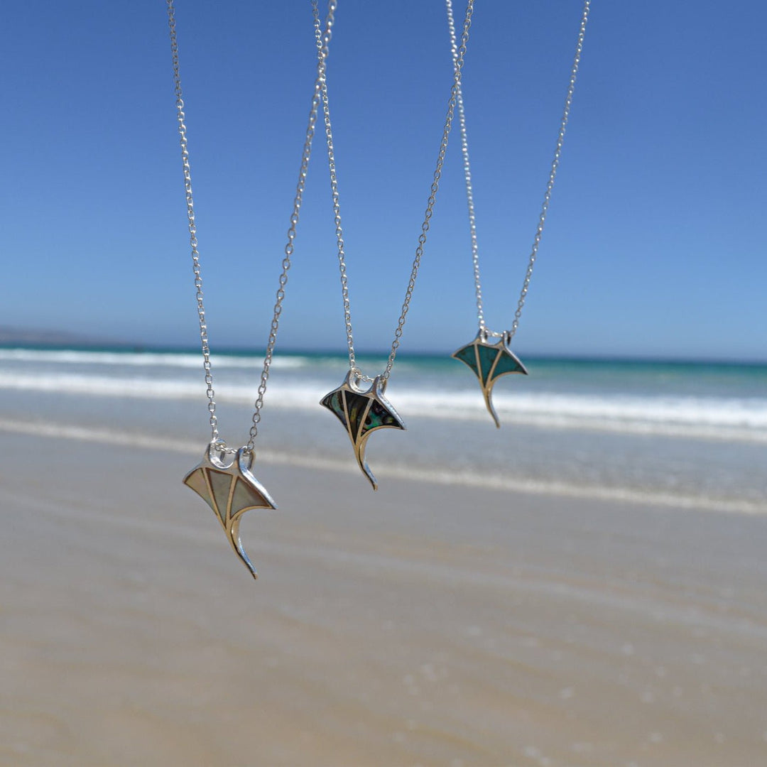 Ocean jewellery collection featuring manta ray necklaces in turquoise, mother of pearl, and abalone shell