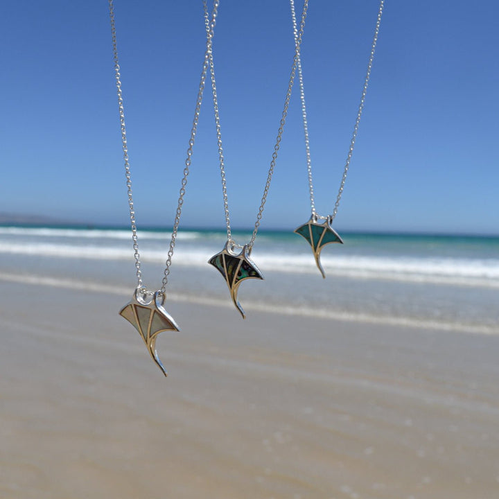 Ocean jewellery collection featuring manta ray necklaces in turquoise, mother of pearl, and abalone shell