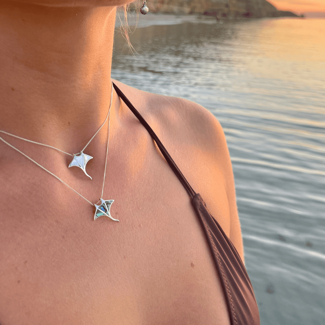 Close-up of abalone shell in manta ray necklace worn on model, ocean-inspired jewellery