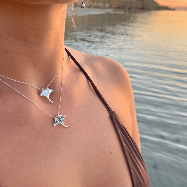 Close-up of abalone shell in manta ray necklace worn on model, ocean-inspired jewellery