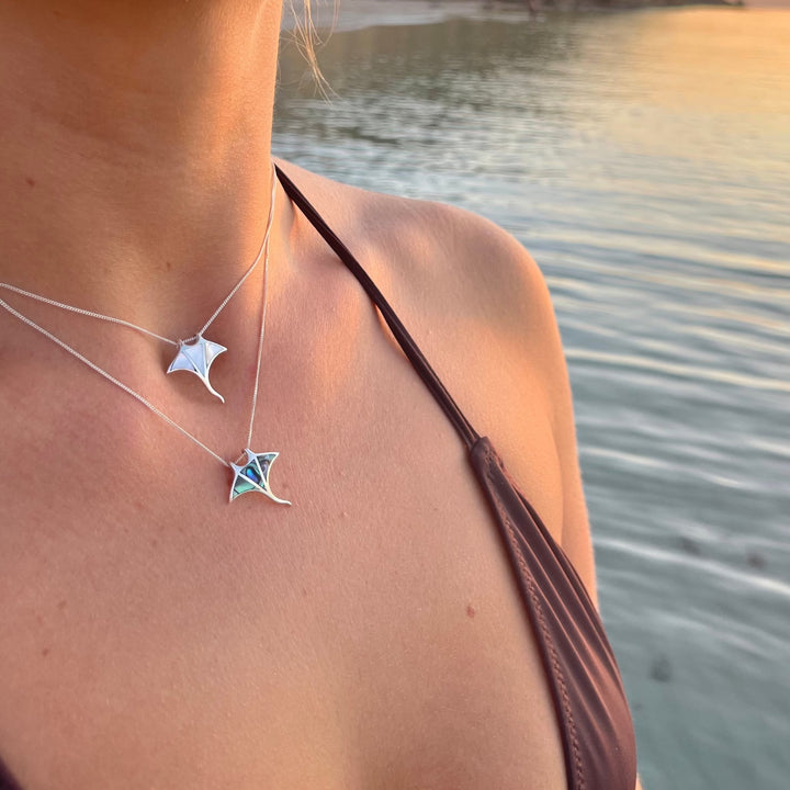 Mother of pearl manta ray pendant necklace worn layered with ocean-inspired jewellery