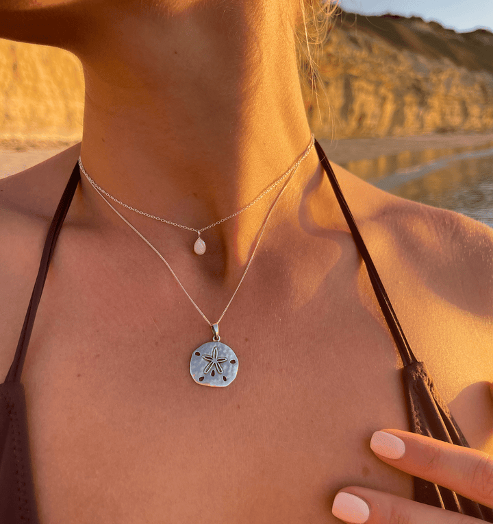 White opal pear pendant necklace styled with layered coastal jewellery