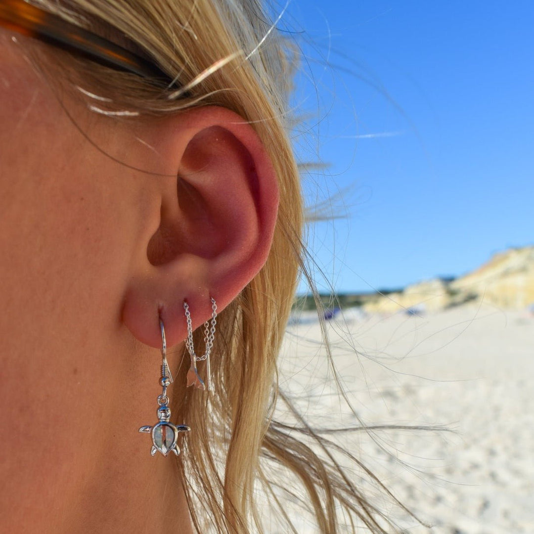 Sterling silver whale tail threader earrings styled with beach jewellery layers