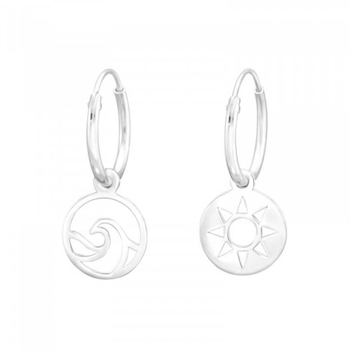 Sterling silver mismatched hoop earrings with wave and sun charms on white background
