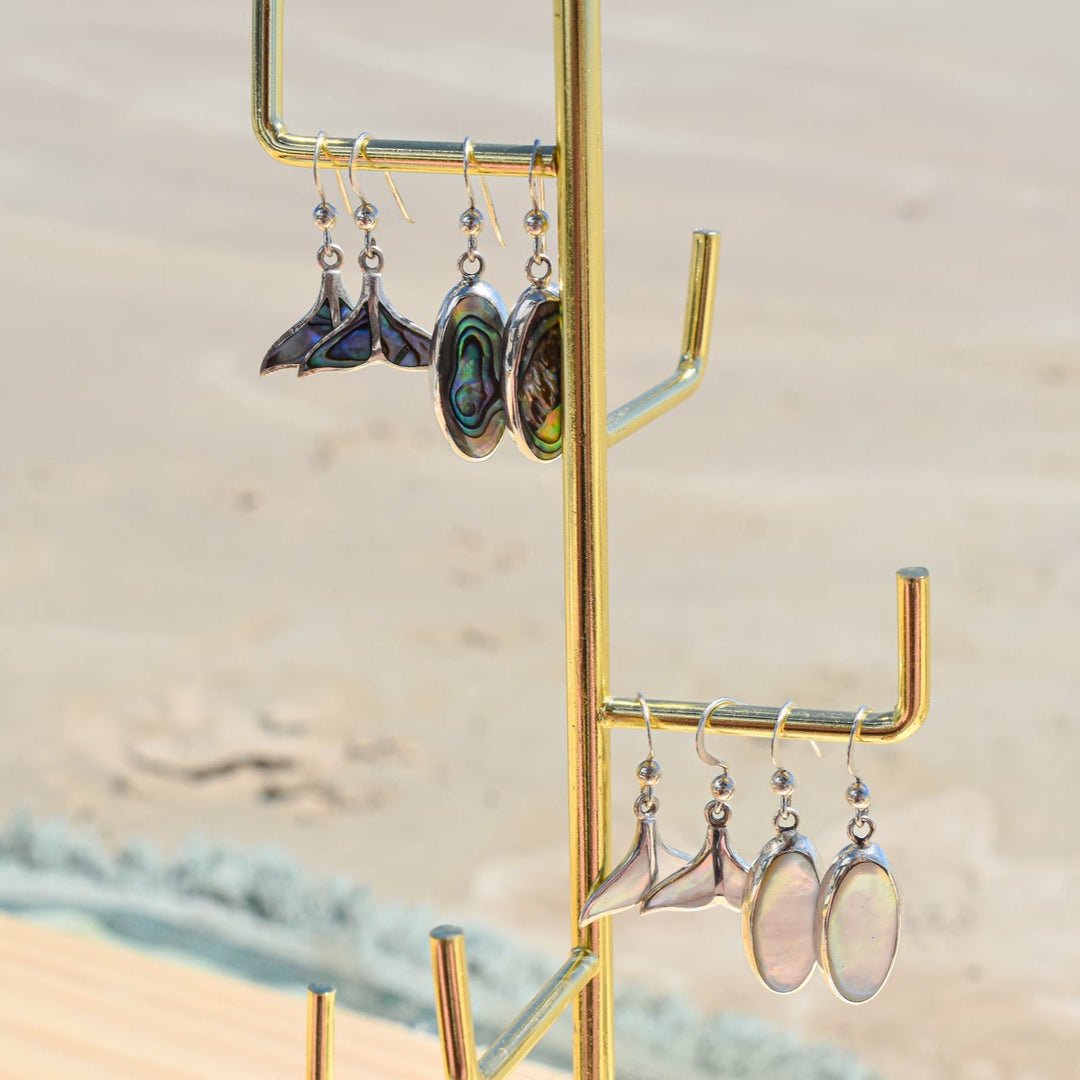 Ocean-inspired whale tail earrings with abalone shell styled with beachy jewellery