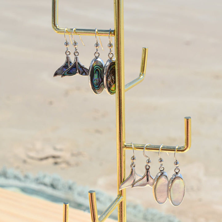Ocean-inspired whale tail earrings with abalone shell styled with beachy jewellery
